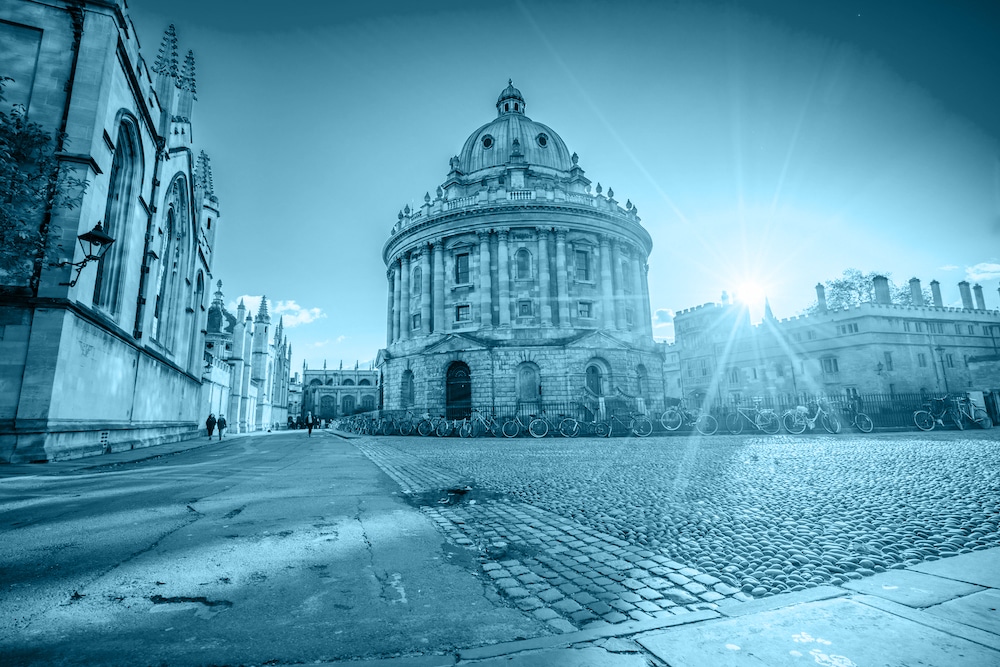 Radcliffe square with Science Library and sunset flare in Oxford, England.